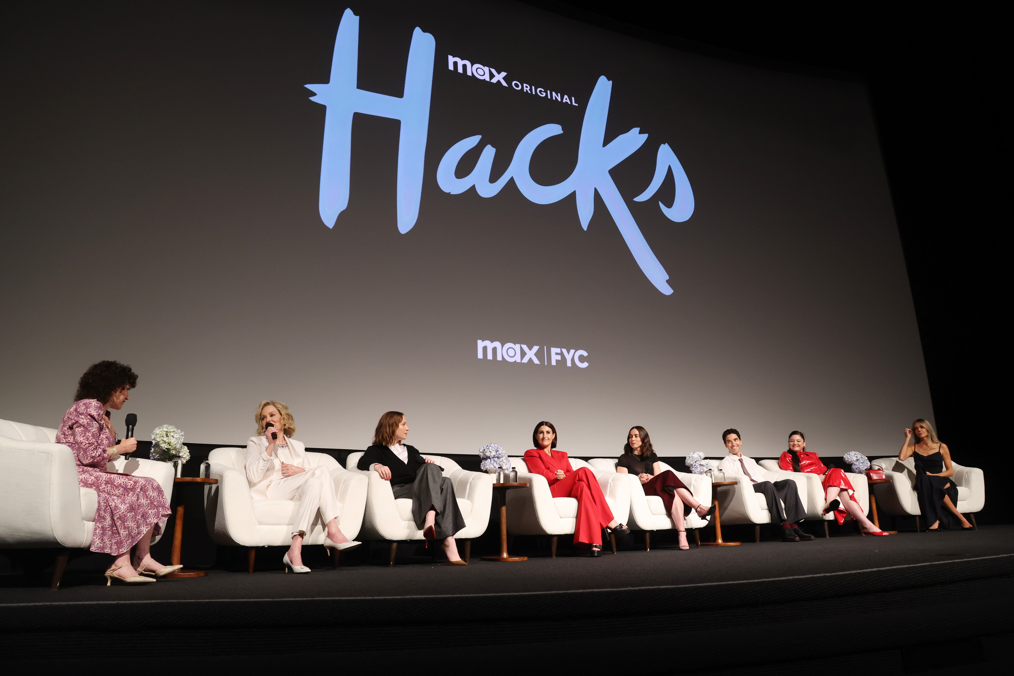 Susie Essman, Jean Smart, Hannah Einbinder, Jen Statsky, and Lucia Aniello, Paul W. Downs, Megan Stalter, and Kaitlin Olson speak onstage during the 'Hacks' Season 4 FYC event in Los Angeles, California.