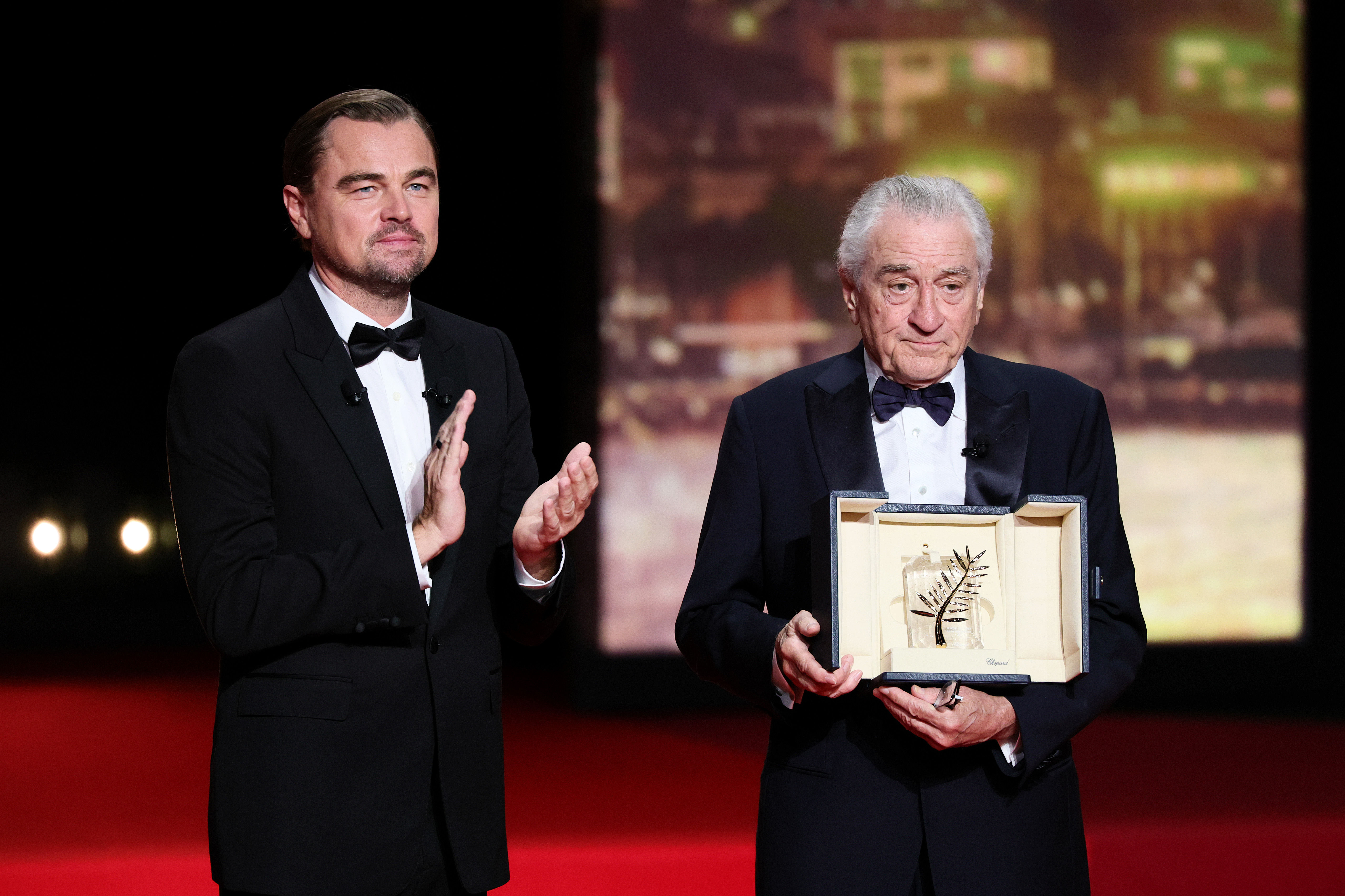 CANNES, FRANCE - MAY 13: Robert De Niro (R) accepts the honorary Palme d'Or from Leonardo DiCaprio onstage during the opening ceremony at the 78th annual Cannes Film Festival at the Palais de Festival on May 13, 2025 in Cannes, France. (Photo by Andreas Rentz/Getty Images)