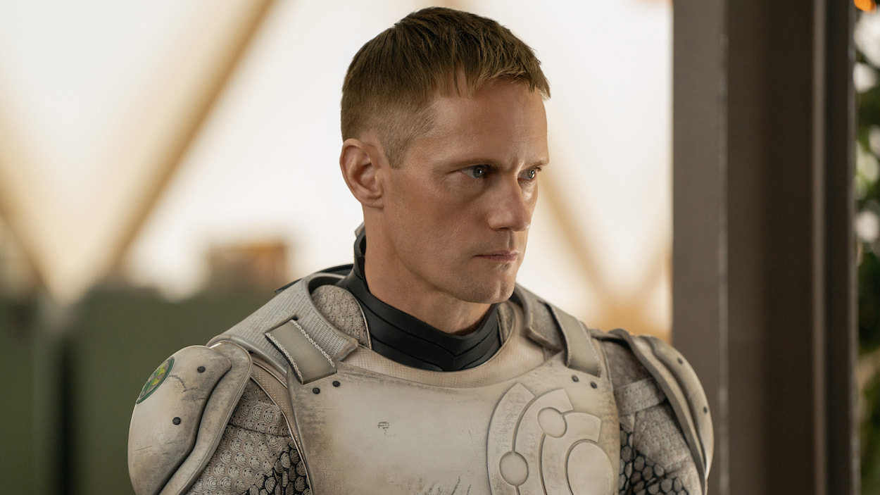 Alexander Skarsgård in 'Murderbot,' shown here with his mask off, armor on, staring determinedly to his left