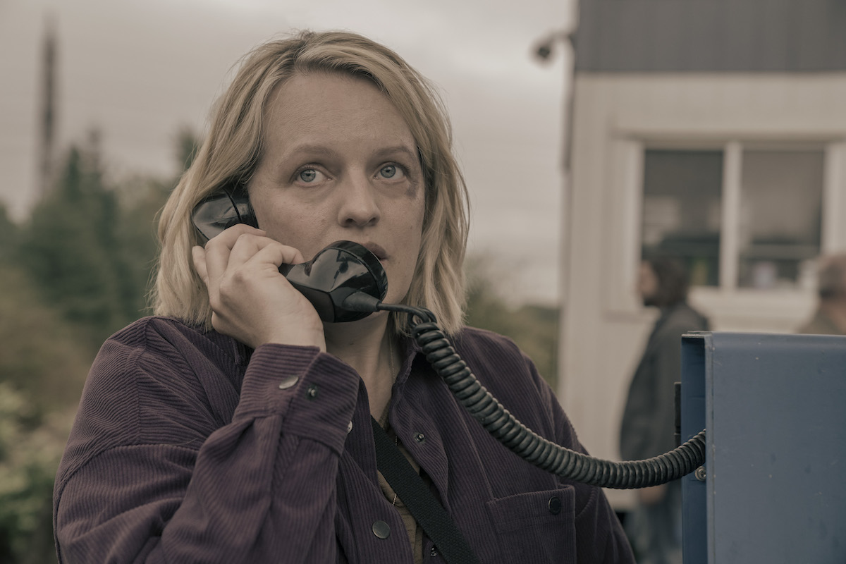THE HANDMAID'S TALE Season 6 stars Elisabeth Moss as June, shown here on the phone, trying to settle in a new community.