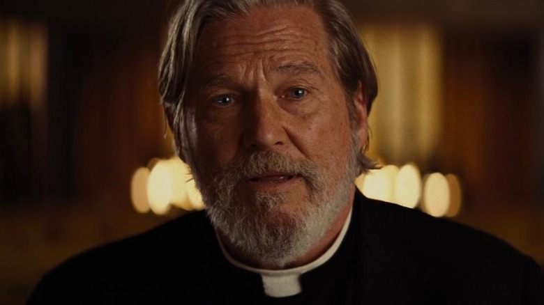 Father Daniel Flynn looking at camera in Bad Times at the El Royale (2018)