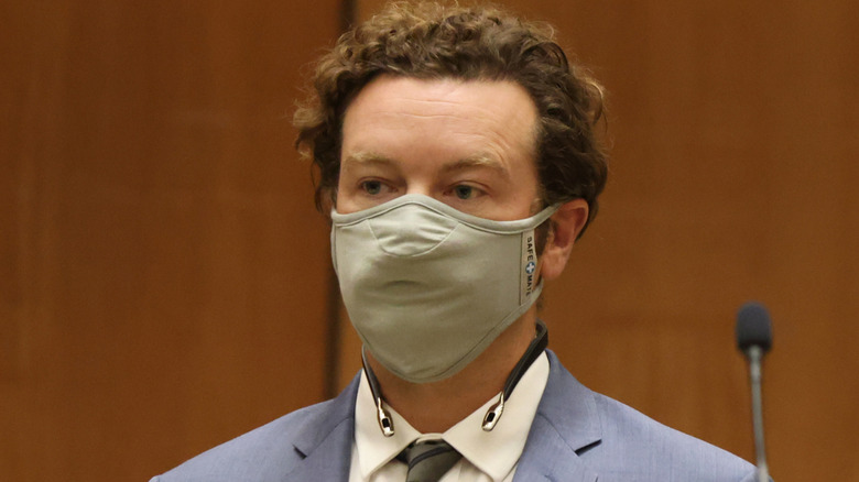 Danny Masterson wears a face mask and suit in court