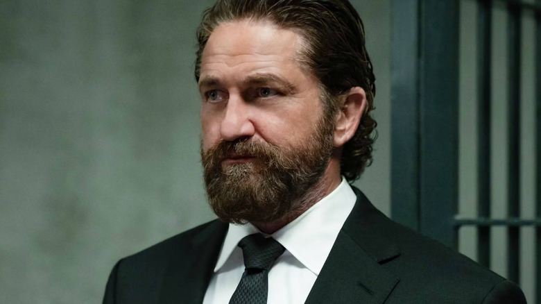 Nicholas O'Brien wearing a suit in Den of Thieves: Pantera