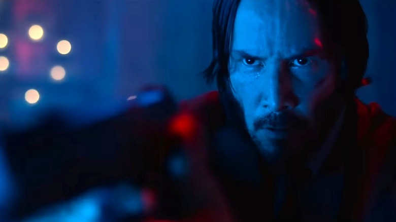 John Wick taking aim with a gun in John Wick (2014)