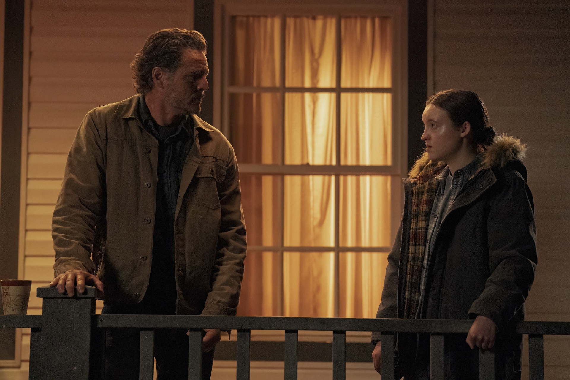 Bella Ramsey and Pedro Pascal facing each other on a porch at night in 'The Last of Us' Season 2, Episode 6, 'The Price' 