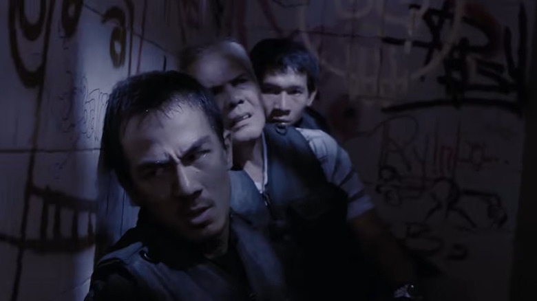 Three of the police officers in the hall of the apartment building in The Raid: Redemption (2011)