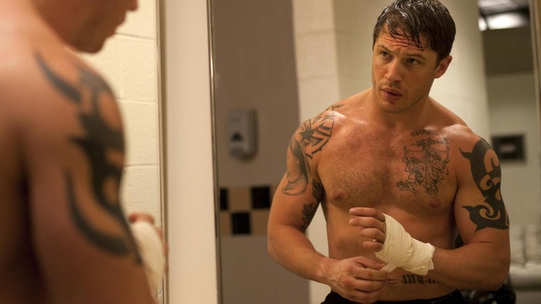 Brendan looks in the mirror while wrapping his fist in "Warrior" (2011)