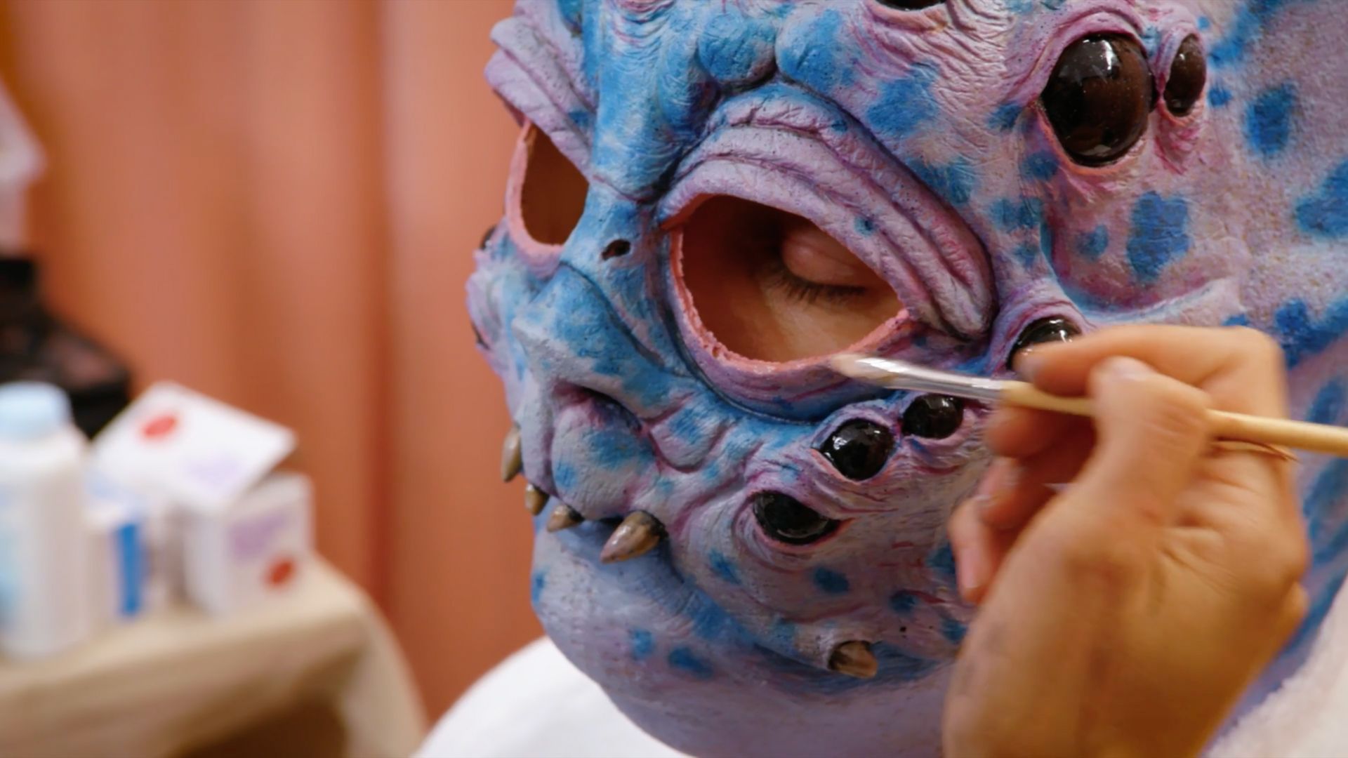 Paul F. Tomkins getting a creature makeup applied in 'Very Important People'