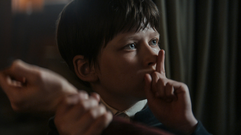 The Boy making a shushing motion on 1899