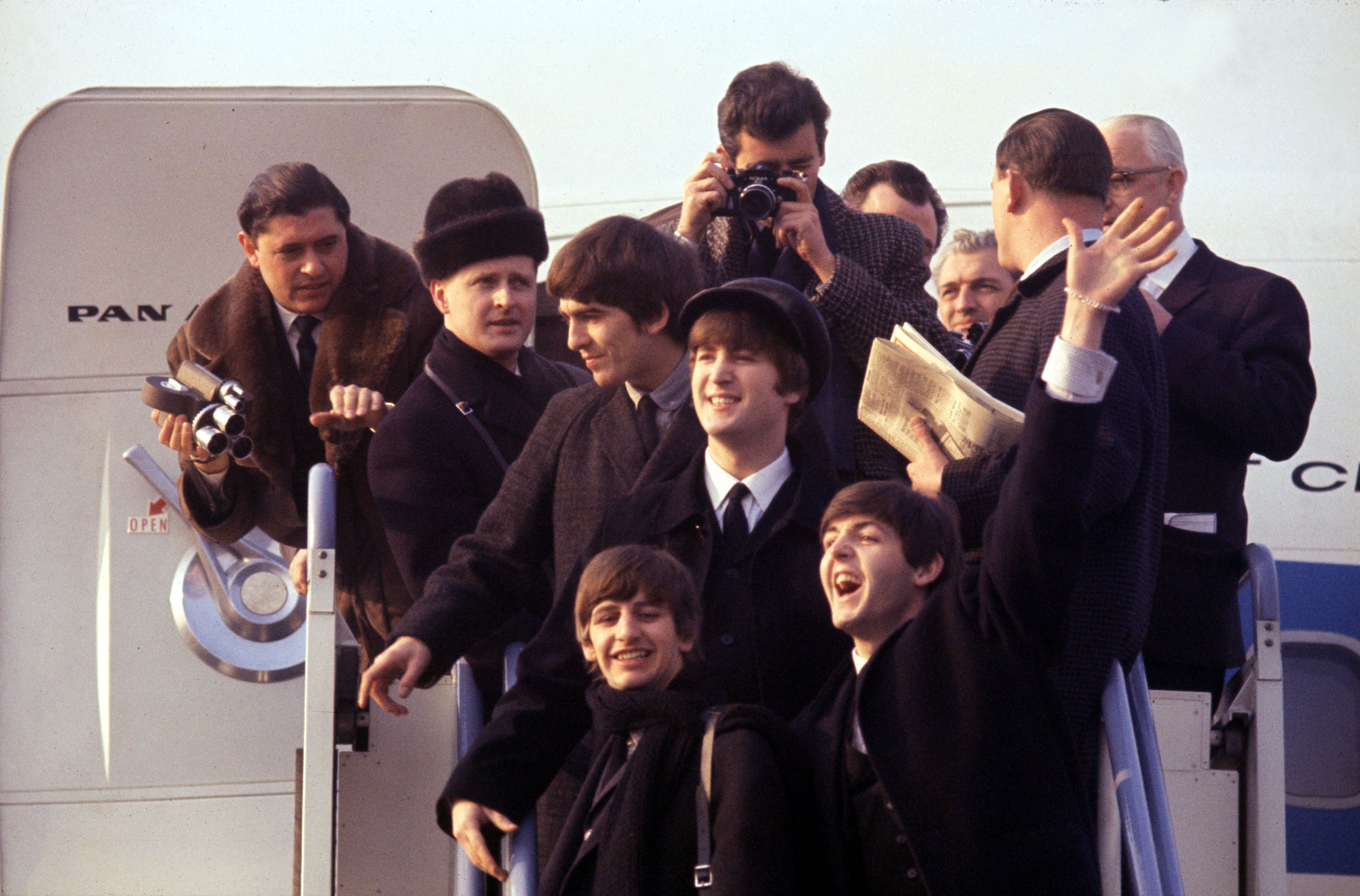(L-R) George Harrison, Ringo Starr, John Lenon, and Paul Mccartney arriving at JFK airport in BEATLES 64'. Photo Courtesy of Apple Corps, Ltd. All Rights Reserved.