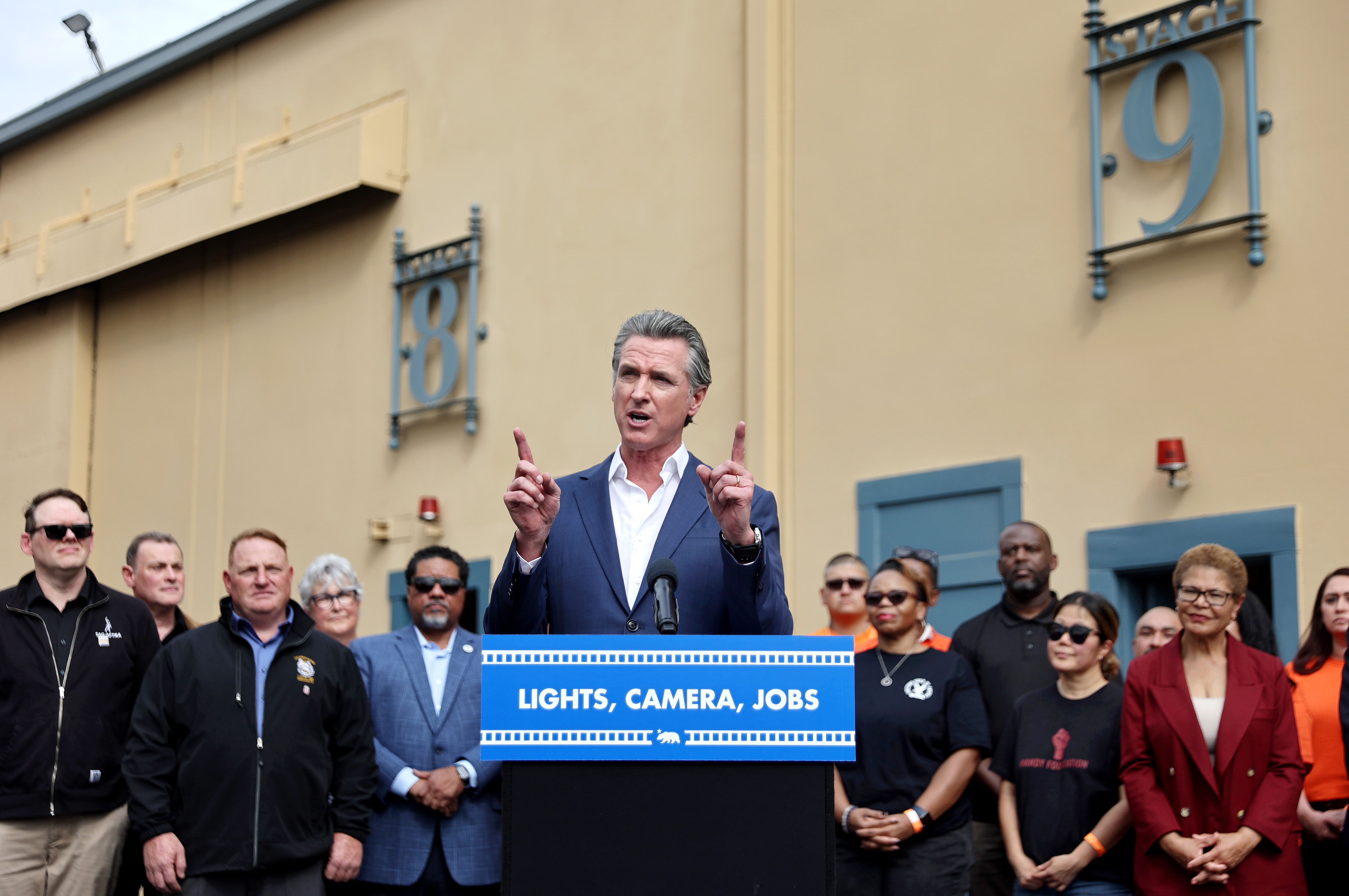 LOS ANGELES, CALIFORNIA - OCTOBER 27: California Governor Gavin Newsom speaks as Los Angeles Mayor Karen Bass (R) looks on during a press conference at Raleigh Studios unveiling a vast expansion of California’s Film and Television Credit Program on October 27, 2024 in Los Angeles, California. Their proposal would expand the program to $750 million annually, a major increase from the $330 million currently allocated, amid sluggish film and TV productions in Hollywood and across California. (Photo by Mario Tama/Getty Images)
