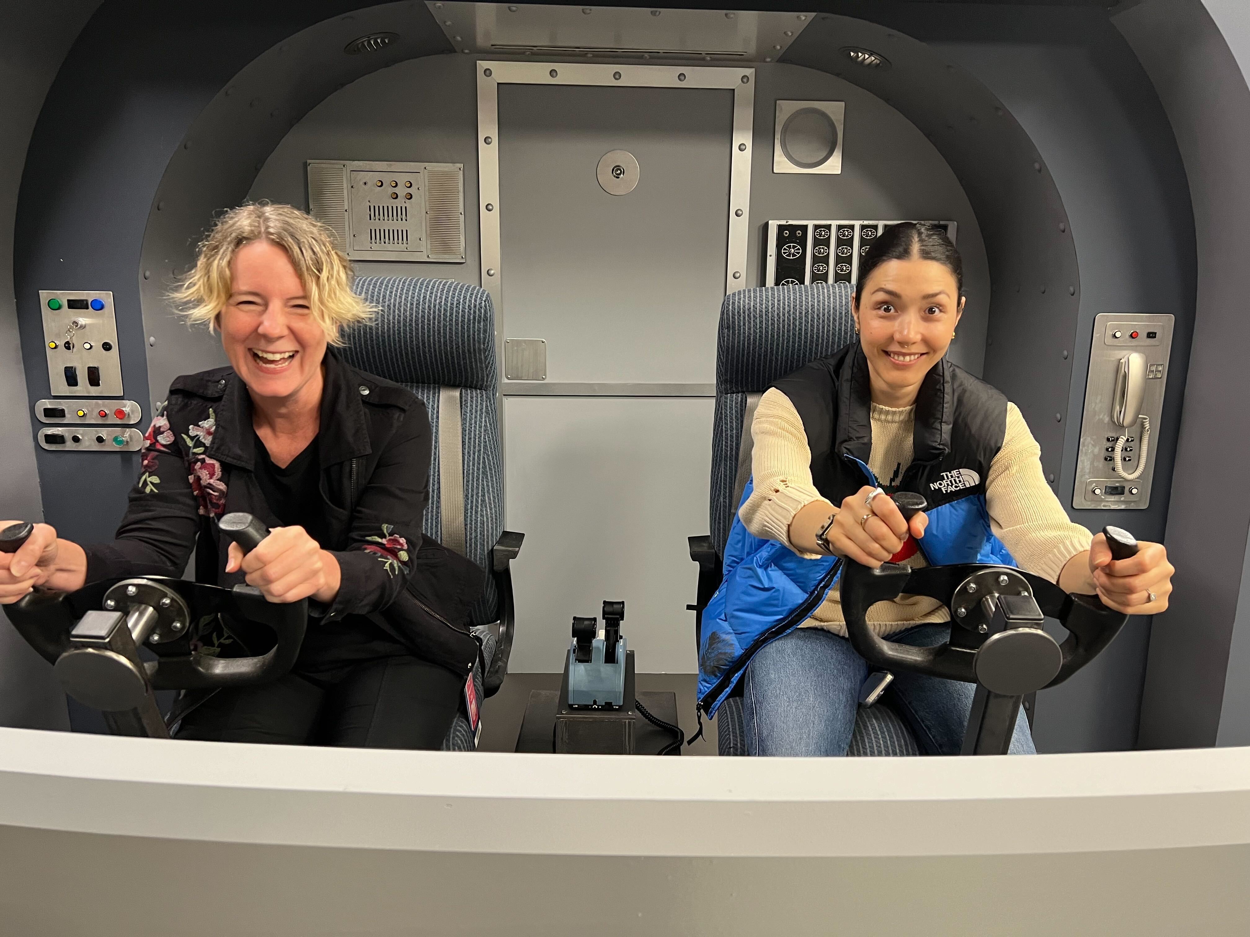 Production designers Heather Wolensky and Kelly Hanson behind the controls of a space ship set on 'The Tonight Show'