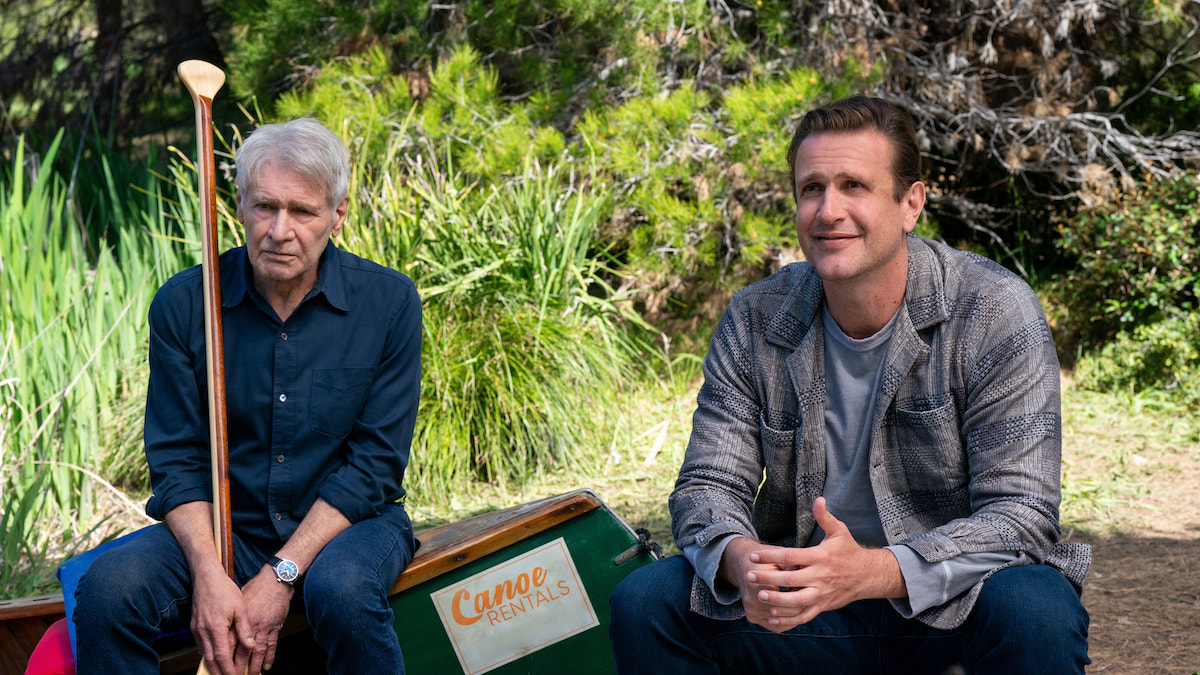 'Shrinking' stars Harrison Ford and Jason Segel, shown here sitting on a canoe on the shore