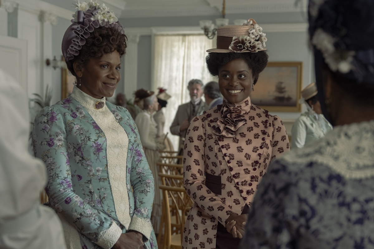 Audra McDonald and Denée Benton in 'The Gilded Age' Season 3, shown here smiling at a party
