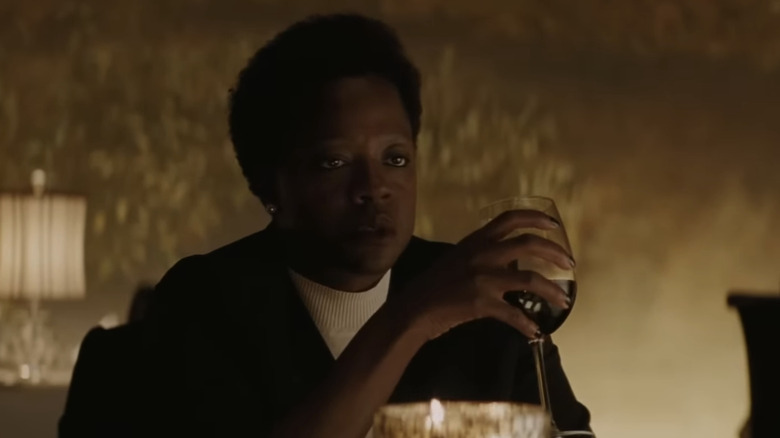 Amanda Waller holds a glass of wine in "Suicide Squad" (2016)