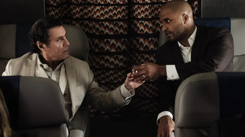 Mr. Wednesday and Shadow Moon sitting on an airplane in "American Gods."