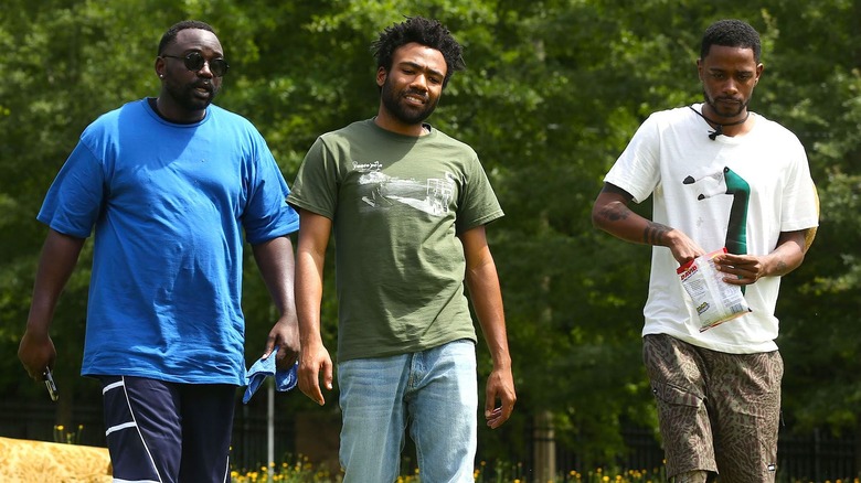 Paper Boi, Earn, and Darius walk outside in "Atlanta" (2016-2022)