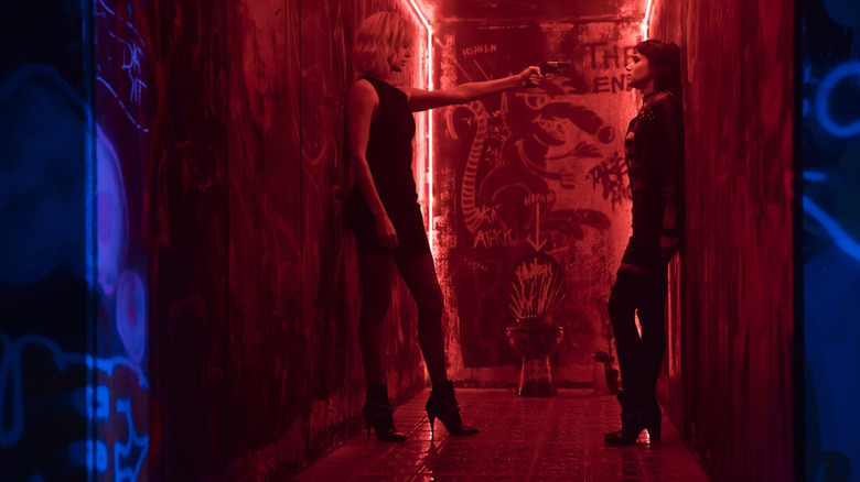 MI6 Agent Lorraine Broughton holding French agent Delphine Lasalle at gunpoint in a graffiti-ridden hallway