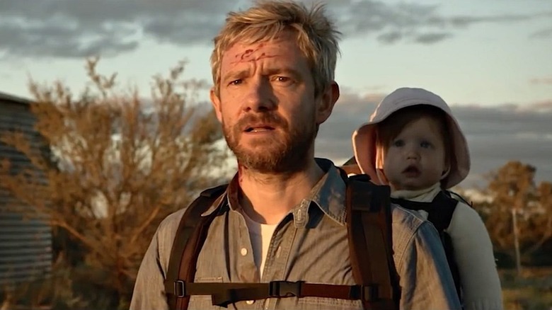 Andy carries Rosie on his back in "Cargo" (2017)