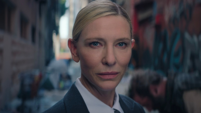 Cate Blanchett's character smirking into camera in Squid Game (2025)
