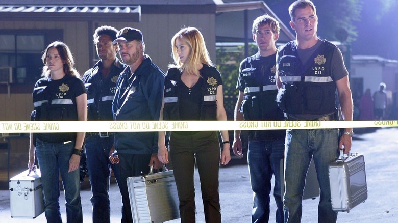 Gill and the crew outside a crime scene in "CSI"
