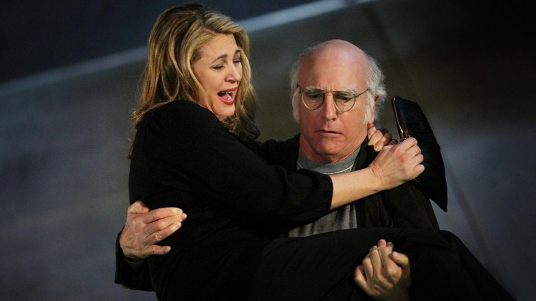 Larry carries a woman up the stairs in "Denise Handicap"