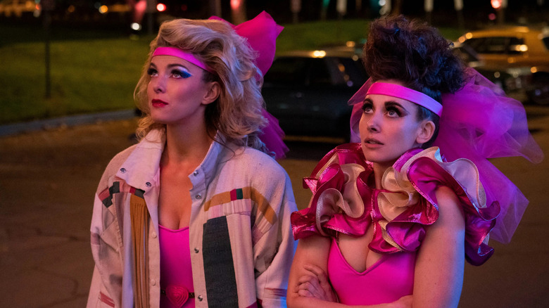 Ruth and Debbie in their costumes looking up in Glow