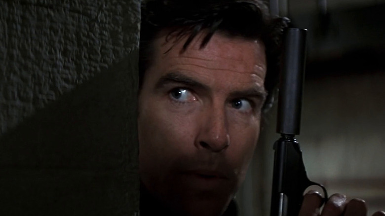 MI6 Agent James Bond (Pierce Brosnan) lurking in the shadows with a gun in hand