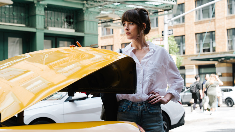 Lucy opens the trunk of a taxi in "Materialists" (2025)