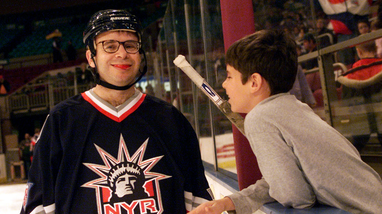 Rick Moranis in a hockey jersey with his son