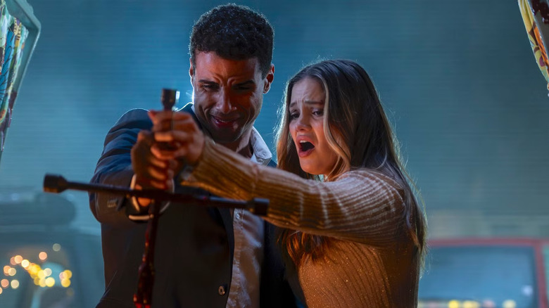 Ally and Jay hold a tire iron together in "Heart Eyes" (2025)