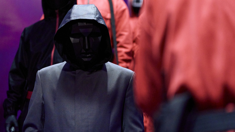The Front Man surrounded by pink guards (2024)