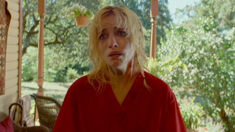 The Lady looking terrified on front porch in "Strange Darling" (2024)