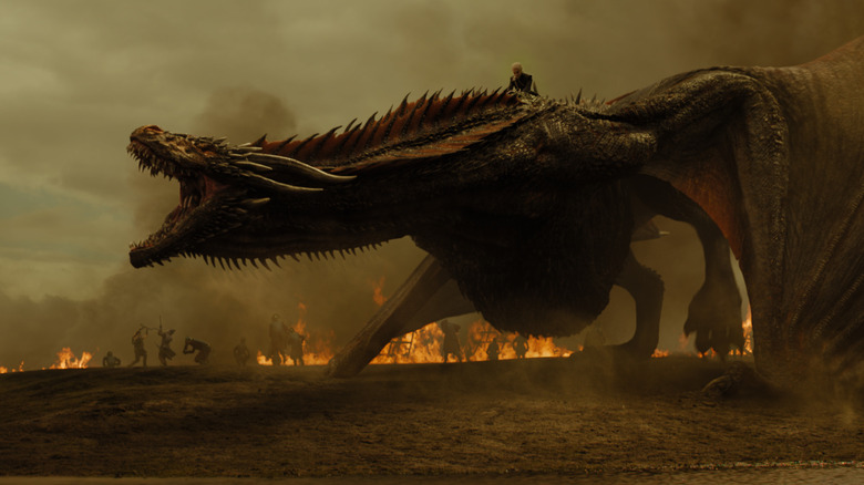 Drogon screaming and surrounded by flames with Daenerys on his back on Game of Thrones