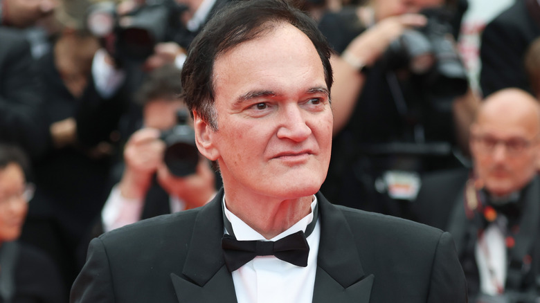 Quentin Tarantino wearing a tuxedo on a red carpet