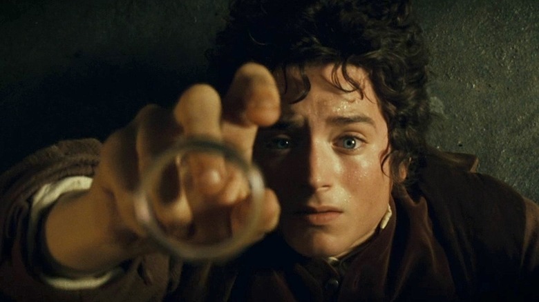Frodo Baggins reaches for the ring in Lord of the Rings: The Fellowship of the Ring (2001)
