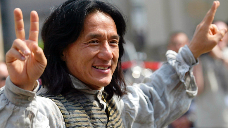 Jackie Chan gives peace signs on the set of Around the World in 80 Days