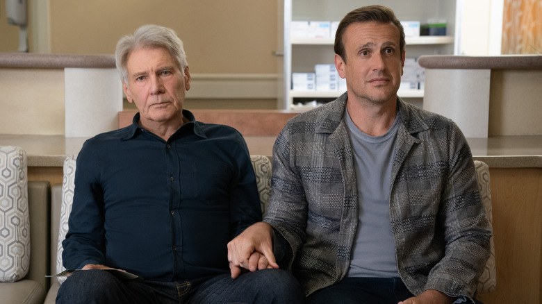 Paul and Jimmy sitting and holding hands on Shrinking