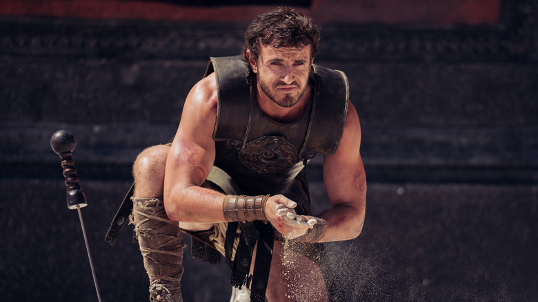 Lucius rubbing his hands in the sand in Gladiator II (2024)