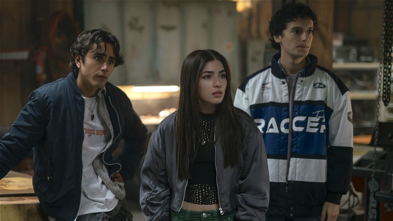Zac, Caitlyn, and Marcel standing in shop (2025)