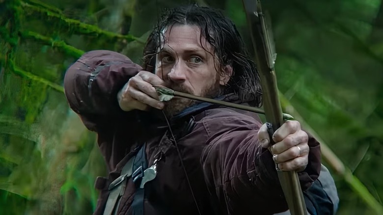 Jamie pulling on a bow and arrow in 28 Years Later