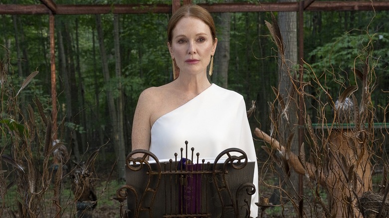 Michaela standing in front of a bird enclosure in "Sirens."