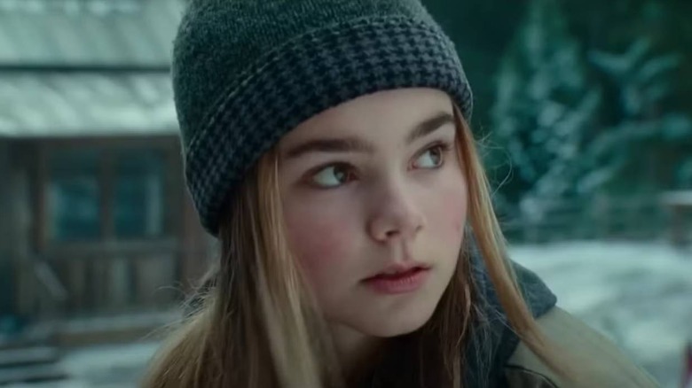 Maisie by a cabin in Jurassic World Dominion