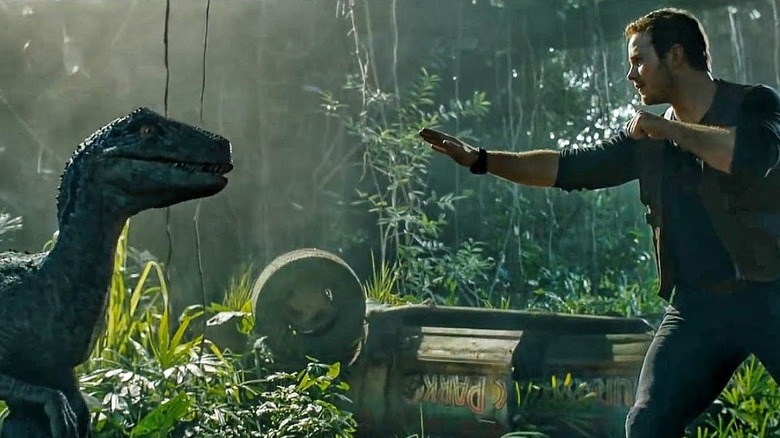 Owen trying to calm down Blue in Jurassic World: Fallen Kingdom
