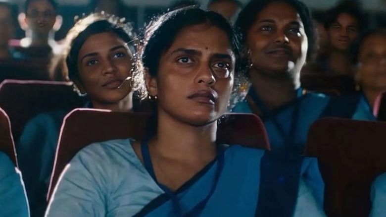 Nurse Prabha watching intently in a movie theater