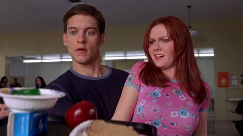 Peter Parker catching food while hanging onto Mary Jane Watson in Spider-Man (2002)