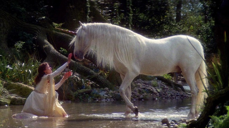Lily reaches for one of the unicorns in Legend (1985)