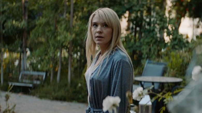 May stands in her garden and looks up in "Lucky" (2020)