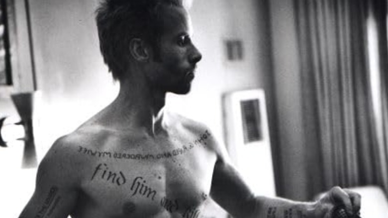 Leonard baring his tattoos