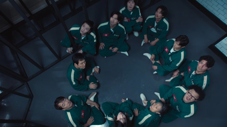 Gi-hun and allies looking up on Squid Game Season 2